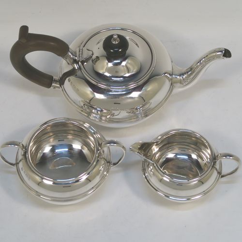 A very handsome Antique Sterling Silver Bachelor three-piece tea set, having plain round bellied shaped bodies, with central applied bands and loop handles, the teapot with a wooden handle and finial, and all sitting on round collet feet. This elegant antique silver bachelor tea set was all made by S. W. Smith and Co., of Birmingham in 1922. The dimensions of this fine hand-made antique silver bachelor tea set are length of teapot 20.5 cms (8 inches), height 10 cms (4 inches), and the total weight is approx. 468g (15 troy ounces).  