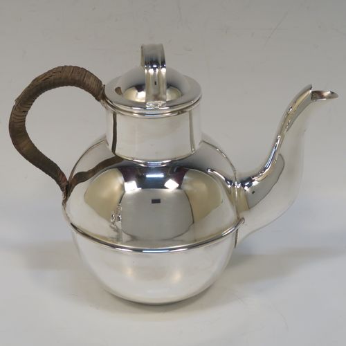 A very stylish and unusual Antique Edwardian Silver-Plated four-piece tea set in a Guernsey style, consisting of teapot, hot-water pot, sugar bowl, and cream jug, all in their original wire-work carrying stand. This beautiful antique silver plated tea set was made by James Collyer of Sheffield in ca. 1910. The dimensions of this fine hand-made antique silver-plated Guernsey tea set and carrying frame are height 21 cms (8.25 inches), length 26.5 cms (10.5 inches), and width 18 cms (7 inches).   