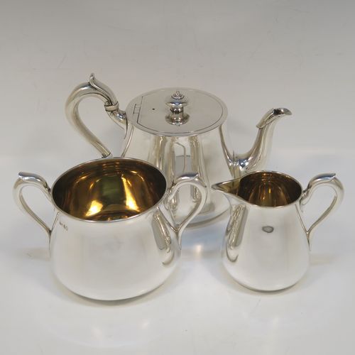 A very handsome Antique Victorian Sterling Silver three-piece tea set, consisting of a teapot, sugar bowl and cream jug. The bodies in a plain round bellied style with scroll handles, the teapot with a flat topped hinged lid and a silver handle and finial, the sugar bowl and cream jug with gold-gilt interiors, and all sitting on flat bases. This elegant silver tea set was made by Hunt and Roskell of London in 1878. The dimensions of this fine hand-made antique silver tea service are length of teapot 20 cms (8 inches), height 12.5 cms (5 inches), and it weighs a total of approx. 950g (31 troy ounces).  