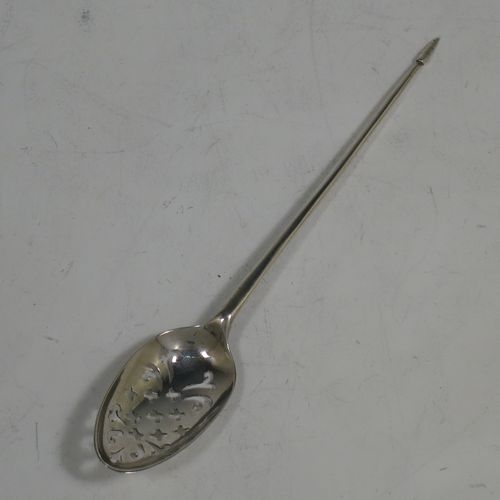 A rare Antique Georgian Sterling Silver mote tea strainer spoon, having a hand-pierced oval bowl with scroll and hatched decoration, the reverse with hand-chased floral and scroll picture-back decoration, and with a handle having a pointed end for clearing teapot spouts. Made in London in ca. 1770. The dimensions of this fine hand-made antique silver mote spoon are length 13 cms (5 inches), and width of bowl 2.3 cms (0.8 inches).   