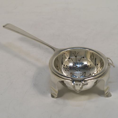 A very elegant Sterling Silver tea strainer and bowl in an Art Deco style, having an Athenian pattern handle, a round hand-pierced bowl with two side holder lugs, and sitting on a plain round dregs bowl with three flange feet. This handsome Art Deco silver tea strainer was made by Cooper Brothers of Sheffield in 1937. The dimensions of this fine hand-made silver tea strainer & bowl are length 15 cms (6 inches), diameter of bowl 6.5 cms (2.5 inches), with a total weight of approx. 98g (3.2 troy ounces).  