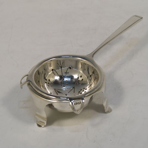 A very elegant Sterling Silver tea strainer and bowl in an Art Deco style, having an Athenian pattern handle, a round hand-pierced bowl with two side holder lugs, and sitting on a plain round dregs bowl with three flange feet. This handsome Art Deco silver tea strainer was made by Cooper Brothers of Sheffield in 1937. The dimensions of this fine hand-made silver tea strainer & bowl are length 15 cms (6 inches), diameter of bowl 6.5 cms (2.5 inches), with a total weight of approx. 98g (3.2 troy ounces).  