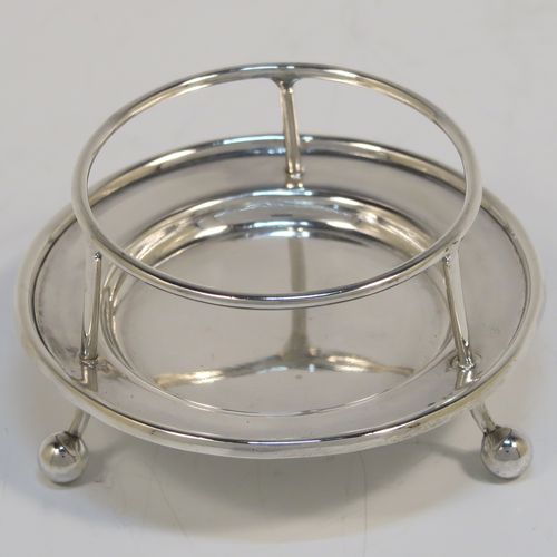 A very stylish Antique Sterling Silver tea strainer and stand, having a round hand-pierced bowl with two florally pierced side-handles, all sitting on an original plain round dregs stand with a wire-work galleried holder on a base with three ball feet. This elegant antique silver tea strainer and stand was made by George Howson of Sheffield in 1920. The dimensions of this fine hand-made antique silver tea strainer and stand are height 4 cms (1.5 inches), length over handles 10 cms (4 inches), and it weighs a total of approx. 80g (2.6 troy ounces).  