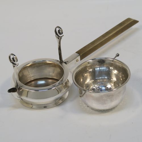 A very unusual Antique Edwardian Sterling Silver gimble-mounted tea strainer on a teapot style stand, having a round hand-pierced bowl mounted on two side stands, all sitting on an original plain round dregs stand in the shape of a teapot, together with an original wooden insulated side-handle. This rare antique silver tea strainer and stand was made by Fredericks Ltd., of London in 1907. The dimensions of this fine hand-made antique silver tea strainer and stand are height 5.5 cms (2.25 inches), length including handle 17 cms (6.75 inches), and it weighs a total of approx. 50g (1.6 troy ounces).   