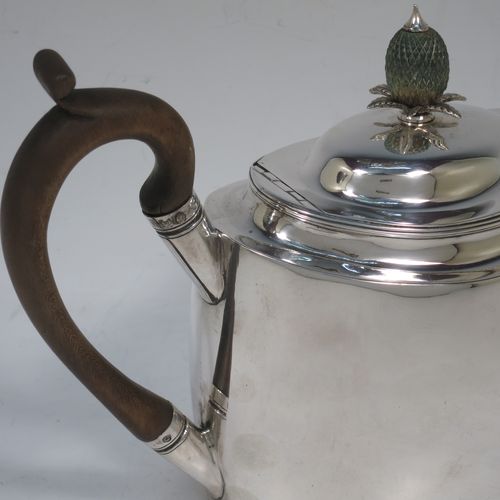 A very handsome Antique Georgian Sterling Silver teapot, having a plain oval body with slightly curved sides, a curved tapering spout, a wooden scroll handle and pineapple shaped finial, an invisibly hinged domed lid, and all sitting on a flat base. Made by William Welch of Exeter in 1801. The dimensions of this fine hand-made antique silver teapot are length 27 cms (10.5 inches), height 16 cms (6.3 inches), and it weighs approx. 350g (11.3 troy ounces).   