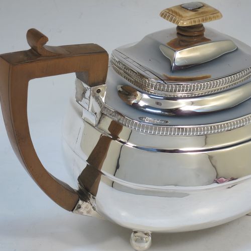 A very handsome Antique Georgian Sterling Silver teapot, having a rectangular bellied body with hand-chased reeded decoration and applied upper gadroon borders, a brown wooden handle with thumb-piece, a domed lid with a bone finial and a flat invisible hinge, a plain square cross-section spout, and all sitting on four ball feet. Made by William Bennett of London in 1811. The dimensions of this fine hand-made antique silver teapot are length 28 cms (11 inches), width 12.5 cms (5 inches), height 15 cms (6 inches), and it weighs approx. 558g (18 troy ounces).   