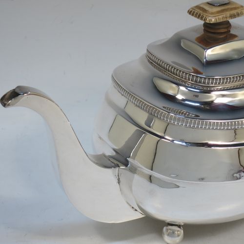 A very handsome Antique Georgian Sterling Silver teapot, having a rectangular bellied body with hand-chased reeded decoration and applied upper gadroon borders, a brown wooden handle with thumb-piece, a domed lid with a bone finial and a flat invisible hinge, a plain square cross-section spout, and all sitting on four ball feet. Made by William Bennett of London in 1811. The dimensions of this fine hand-made antique silver teapot are length 28 cms (11 inches), width 12.5 cms (5 inches), height 15 cms (6 inches), and it weighs approx. 558g (18 troy ounces).   