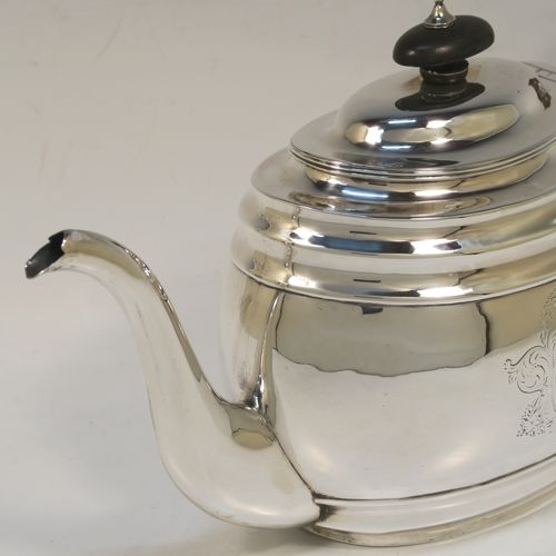 A very handsome Antique Georgian Sterling Silver teapot, having a plain oval body with curved sides and reeded decoration, with engraved vacant cartouches on both sides, a curved tapering spout, a wooden scroll handle and finial, an invisibly hinged domed lid, and all sitting on a flat base. This elegant Georgian silver teapot was made by Soloman Hougham of London in 1800. The dimensions of this fine hand-made antique silver teapot are length 28 cms (11 inches), height 16 cms (6.3 inches), and it weighs approx. 450g (14.5 troy ounces).  