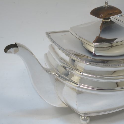 A very handsome Sterling Silver teapot, having a rectangular bellied body with two hand-chased girdle bands and an applied upper gadroon border, a brown wooden handle with thumb-piece, a domed lid with wooden finial, a plain square cross-section spout, and all sitting on four ball feet. Made by S. Blankensee and Sons of Chester in 1933. The dimensions of this fine hand-made silver teapot are length 27 cms (10.5 inches), width 13 cms (5 inches), height 15 cms (6 inches), and it weighs approx. 698g (22.5 troy ounces).   