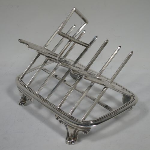 A very unusual Arts and Crafts style Antique Victorian Sterling Silver seven-bar toast-rack, in a very angular style inspired by a Christopher Dresser design, attached to a rectangular base with a reeded border and a strengthening strut, and sitting on four cast foliate and scroll feet. Made by Henry Stratford (who had links with Christopher Dresser) of Sheffield in 1893. The dimensions of this fine hand-made antique silver toast-rack are length 16 cms (6.25 inches), height 14 cms (5.5 inches), width 10 cms (4 inches), and it weighs approx. 348g (11.2 troy ounces).   