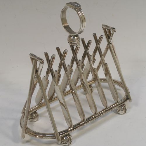 A very unusual Antique Victorian Silver-Plated seven-bar toast-rack, having crossed cricket bats with wickets and bails, and sitting on a rounded rectangular base with four cricket ball feet, and a round loop handle. This beautiful and rare Cricket designed toastrack was made by Padley, Parkin and Co., of Sheffield in ca. 1880. The dimensions of this fine hand-made antique silver plated cricket toast-rack are length 18 cms (7 inches), height 16 cms (6.3 inches), and width 8 cms (3.25 inches).  