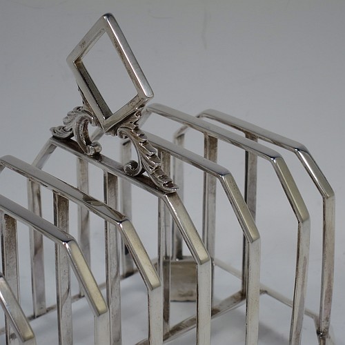 A very handsome and unusual Antique Victorian Sterling Silver seven-bar toast-rack, having plain panelled wire-work bars with central struts, a wire-work diamond-shaped handle, attached to a plain cut-corner rectangular base with a strengthening strut, and sitting on four cast flanged feet. Made by Charles and George Fox of London in 1844. The dimensions of this fine hand-made antique silver toast-rack are length 16 cms (6.3 inches), height 15 cms (6 inches), width 10 cms (4 inches), and it weighs approx. 375g (12 troy ounces).    