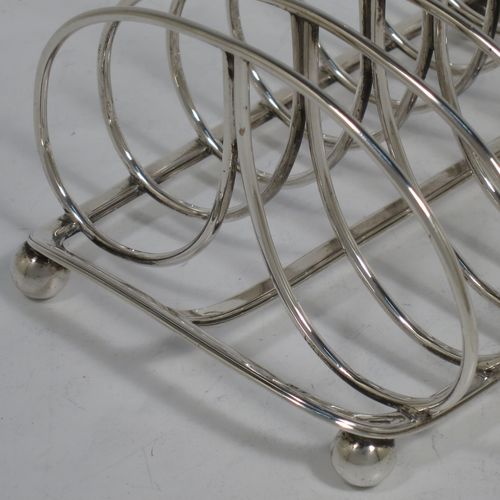 A very handsome Antique Georgian Sterling Silver seven-bar toast-rack, having oval shaped wire-work bars, a loop handle, attached to a rectangular base with a strengthening strut, and sitting on four ball feet. Made by Robinson, Edkins, and Aston of London in 1834. The dimensions of this fine hand-made antique silver toast-rack are length 15 cms (6 inches), height 12 cms (4.75 inches), width 11.5 cms (4.5 inches), and it weighs approx. 242g (7.8 troy ounces).    