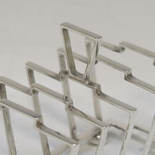 A very stylish Art Deco Sterling Silver five-bar toast-rack, in a very angular style design, attached to a rectangular base and sitting on four round cushion feet. this elegant silver toastrack was made by Alexander Clark and Co., of Birmingham in 1932. The dimensions of this fine hand-made Art Deco silver toast-rack are length 13.5 cms (5.25 inches), height 10 cms (4 inches), width 7 cms (2.75 inches), and it weighs approx. 127g (4 troy ounces).  