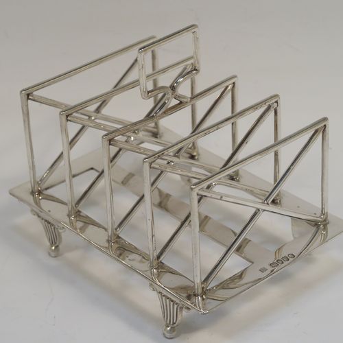 A very unusual Arts and Crafts style Antique Victorian Sterling Silver five-bar toastrack, having  square crossed wire-work bars, with a square loop handle, and sitting on a base with a strengthening strut and four fluted and flanged feet. This elegant Arts and Crafts silver toast-rack was made by Edward Hutton of London in 1881. The dimensions of this fine hand-made antique silver toast-rack are length 12.5 cms (5 inches), height 11 cms (4.3 inches), width 9 cms (3.5 inches), and it weighs approx. 259g (8.4 troy ounces).   