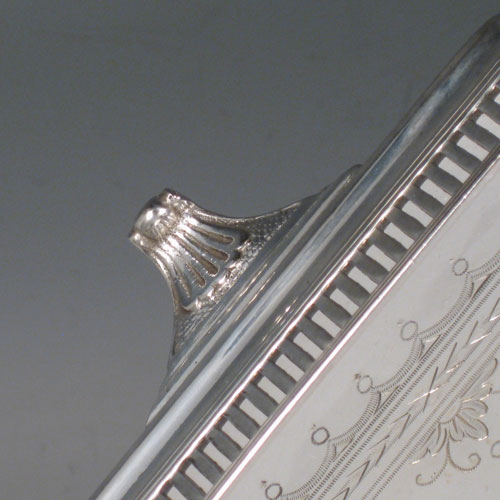 Antique Victorian silver plated tray, having an octagonal sided body, a hand-engraved ground with geometrical and floral swag decoration, a hand-pierced gallery edge, two cast reeded handles, and sitting on four cast reeded flange feet. This beautiful silver-plated tray was made by Latham and Morton in ca. 1880. The dimensions of this fine hand-made silver plated tea tray are length (inc. handles) 53 cms (21 inches), width 33 cms (13 inches).   