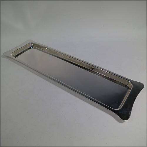 An Antique Edwardian Sterling Silver sandwich tray, having a long plain rectangular body, a very plain ground, a plain border with lobed corner handles, and sitting on a flat base. Made by Heath and Middleton of Birmingham in 1908. The dimensions of this fine hand-made antique silver sandwich tray are length 46 cms (18 inches), width 13.5 cms (5.25 inches), and it weighs approx. 506g (16.3 troy ounces). 