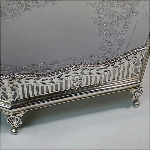 A very pretty Antique Victorian Sterling Silver gallery tray, having an elongated octagonal body, a hand-engraved ground with floral and scroll decoration, hand-pierced gallery sides with applied gadroon borders and oval cut-out handles, and sitting on eight cast shell flange feet. This beautiful silver tray was made by Charles Clement Pilling of Sheffield in 1901. The dimensions of this fine hand-made antique silver tray are length 57 cms (22.5 inches), width 41 cms (16 inches), height 8 cms (3 inches), and it weighs approx. 3,720g (120 troy ounces).    