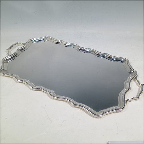 A Sterling Silver tray, having a very plain ground, with an applied Bath edged border, with two cast side-handles, and sitting on a flat base. Made by Bert Gordon of Birmingham in 1949. The dimensions of this fine hand-made silver tray are length (inc. handles) 40 cms (15.75 inches), width 22 cms (8.5 inches), and it weighs approx. 884g (28.5 troy ounces).   