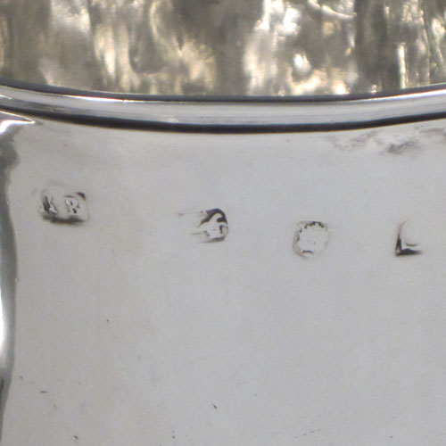 Antique Georgian George II Sterling silver trophy loving cup, having a plain round body with central reeded band, two scroll side-handles which are part-marked with a makers mark, and sitting on a pedestal foot. Made by Benjamin Blakely of London in 1738. The dimensions of this fine silver loving cup are height 14.5 cms (5.75 inches), spread across handles 23 cms (9 inches), and it weighs approx. 511g (16.5 troy ounces).