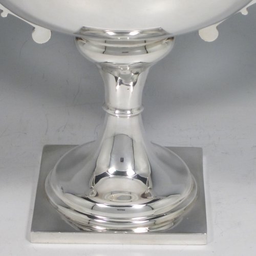 Sterling silver trophy cup, in an Art Deco style having two angular handles, a plain round body, and sitting on a pedestal foot with a square base. Made by the Wilmot Manufacturing Co., of Birmingham in 1927. The dimensions of this fine silver trophy cup are height 15 cms (6 inches), spread across handles 23.5 cms (9.25 inches), and it weighs approx. 361g (11 troy ounces).   