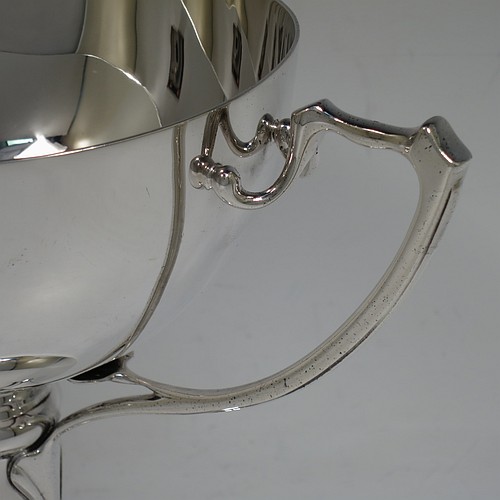 A very handsome Sterling Silver Art Nouveau three-handled trophy cup, having a plain round body, with three handles, and sitting on a pedestal foot. Made by the Adie Brothers of Birmingham in 1922. The dimensions of this fine hand-made sterling silver Art Nouveau trophy cup are height 17 cms (6.5 inches), diameter of main body 15 cms (6 inches), and it weighs approx. 765g (22.7 troy ounces).    