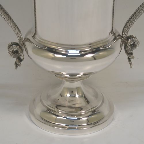 A very handsome Antique Edwardian Sterling Silver trophy cup, having a plain round bellied body with tapering sides, two looped side-handles in the form of twin snakes, and all sitting on a stepped pedestal foot. This elegant silver trophy cup was made by Charles Stuart Harris of London in 1906. The dimensions of this fine hand-made antique silver trophy cup are height 17.5 cms (7 inches), spread across arms 18.5 cms (7.25 inches), and it weighs approx. 438g (14 troy ounces).  