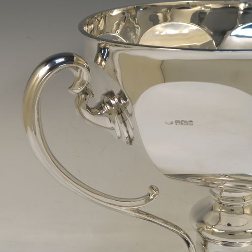 A very handsome and heavy Antique Edwardian Sterling Silver two-handled trophy cup bowl, having a plain hexagonal panelled body, two cast scroll side-handles, and sitting on a square pedestal foot. This elegant antique silver trophy bowl cup was made by Charles Clement Pilling of Sheffield in 1909. The dimensions of this fine hand-made sterling silver trophy cup bowl are height 28.5 cms (11.25 inches), width across handles 37 cms (14.5 inches), and it weighs approx. 2,133g (68.8 troy ounces).   