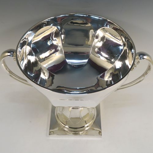 A very handsome and heavy Antique Edwardian Sterling Silver two-handled trophy cup bowl, having a plain hexagonal panelled body, two cast scroll side-handles, and sitting on a square pedestal foot. This elegant antique silver trophy bowl cup was made by Charles Clement Pilling of Sheffield in 1909. The dimensions of this fine hand-made sterling silver trophy cup bowl are height 28.5 cms (11.25 inches), width across handles 37 cms (14.5 inches), and it weighs approx. 2,133g (68.8 troy ounces).   