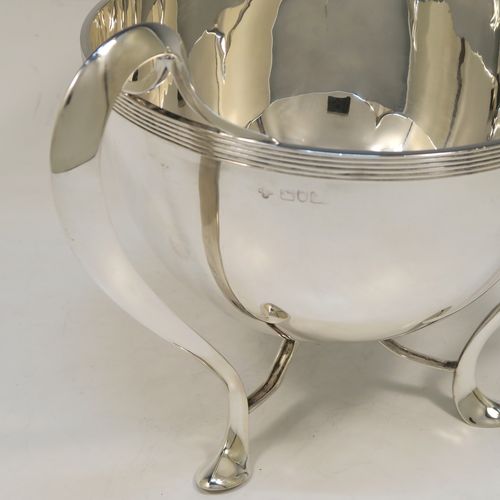 An elegant and heavy Antique Edwardian Sterling Silver three-handled Loving cup bowl, having a plain round body with tapering sides, with three scroll  side-handled feet. This handsome antique silver loving cup trophy bowl was made by Horace Woodward of London in 1903. The dimensions of this fine hand-made sterling silver trophy cup bowl are height 21 cms (8.25 inches), diameter of main body 20 cms (8 inches), and it weighs approx. 1,198g (38.6 troy ounces).  