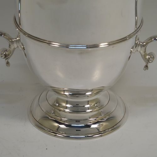 A very elegant and classical Antique Victorian Sterling Silver trophy loving cup, having a plain round body with a central reeded band, two anthemion leaf topped scroll side-handles, and sitting on a round pedestal foot. This handsome antique silver loving cup trophy was made by D. and C. Houle of London in 1875. The dimensions of this fine antique silver loving cup are height 14.5 cms (5.75 inches), spread across handles 21.5 cms (8.5 inches), and it weighs approx. 470g (15 troy ounces).   