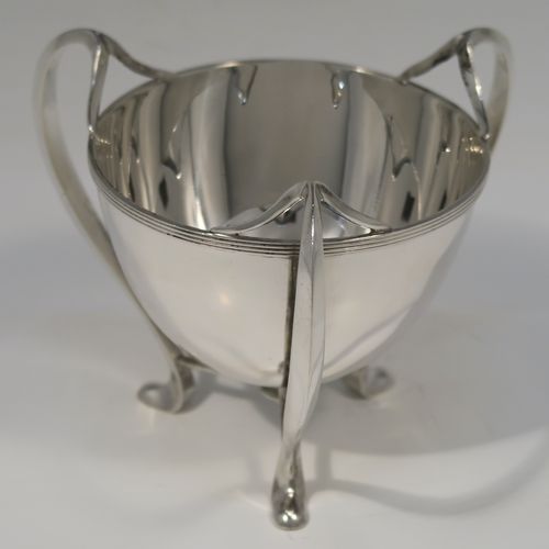 A small but very elegant and heavy Antique Edwardian Sterling Silver three-handled Loving cup bowl, having a plain round body with tapering sides and an applied reeded top border, sitting on three scroll side-handled feet. This handsome antique silver loving cup trophy bowl was made by Horace Woodward of London in 1904. The dimensions of this fine hand-made sterling silver trophy cup bowl are height 11 cms (4.25 inches), diameter of main body 10 cms (4 inches), and it weighs approx. 242g (7.8 troy ounces).   