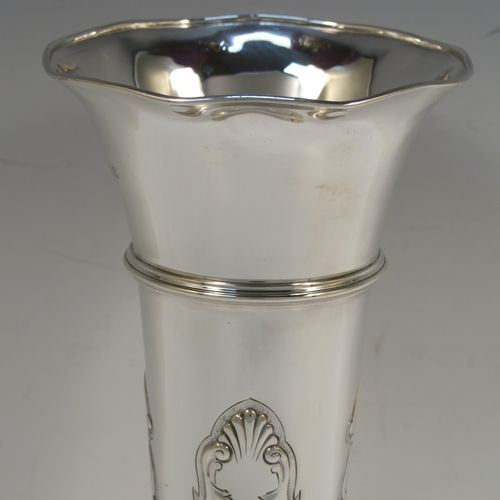 A very handsome Antique Edwardian Sterling Silver large table flower vase, having a tapering round body, with hand-chased floral panel decoration below an upper applied reeded band, and sitting on a pedestal foot. This elegant antique silver flower vase was made by David and George Edward of Sheffield in 1904. The dimensions of this fine hand-made antique silver vase are height 23 cms (19 inches), diameter at top 11 cms (4.25 inches), and it weighs approx. 302g (9.7 troy ounces). Please note that this vase is not loaded, so the whole weight is silver.  