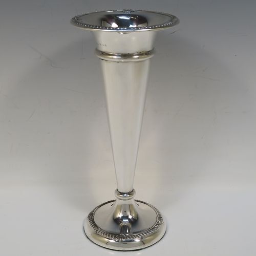 A very handsome Antique Edwardian Sterling Silver large table flower vase, having a plain tapering round body, with applied gadroon and shell borders, and sitting on a round pedestal foot. This elegant antique silver flower vase was made by A. and J. Zimmerman of Birmingham in 1909. The dimensions of this fine hand-made antique silver vase are height 25.5 cms (10 inches), diameter at top 11 cms (4.3 inches).   