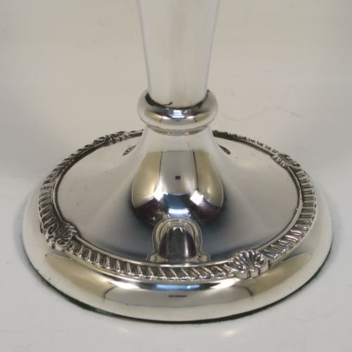 A very handsome Antique Edwardian Sterling Silver large table flower vase, having a plain tapering round body, with applied gadroon and shell borders, and sitting on a round pedestal foot. This elegant antique silver flower vase was made by A. and J. Zimmerman of Birmingham in 1909. The dimensions of this fine hand-made antique silver vase are height 25.5 cms (10 inches), diameter at top 11 cms (4.3 inches).   