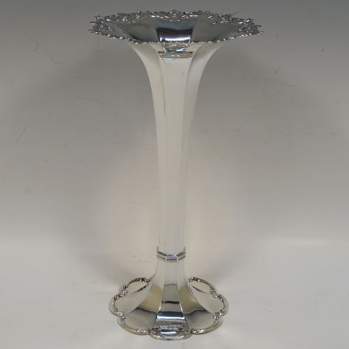 A very pretty Antique Edwardian Sterling Silver large table flower vase, having a plain tapering octagonal panelled body, with a hand-chased scroll and pierced top border, and sitting on an octofoil pedestal foot with a scroll-work border. This beautiful antique silver flower vase was made by James Dixon and Sons of Sheffield in 1905. The dimensions of this fine hand-made antique silver vase are height 23 cms (9 inches), diameter at top 12 cms (4.75 inches), and it weighs 187g (6 troy ounces). Please note that this vase is not loaded, so the whole weight is silver.   