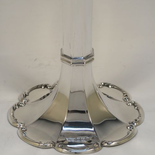 A very pretty Antique Edwardian Sterling Silver large table flower vase, having a plain tapering octagonal panelled body, with a hand-chased scroll and pierced top border, and sitting on an octofoil pedestal foot with a scroll-work border. This beautiful antique silver flower vase was made by James Dixon and Sons of Sheffield in 1905. The dimensions of this fine hand-made antique silver vase are height 23 cms (9 inches), diameter at top 12 cms (4.75 inches), and it weighs 187g (6 troy ounces). Please note that this vase is not loaded, so the whole weight is silver.   