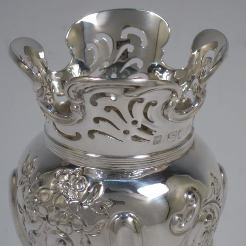 A very pretty pair of Antique Victorian Sterling Silver Art Nouveau style vases, having hand-chased floral and scroll decoration, with hand-pierced upper necks and applied scroll borders, and all  sitting on round stepped pedestal feet. Made by Walter and Charles Sissons of London in 1900. The dimensions of this fine pair of hand-made antique silver Art Nouveau vases are height 17 cms (6.75 inches), and diameter at top 7 cms (2.75 inches). Please note that these vases are not loaded, and the total weight of silver is 422g (13.6 troy ounces).    