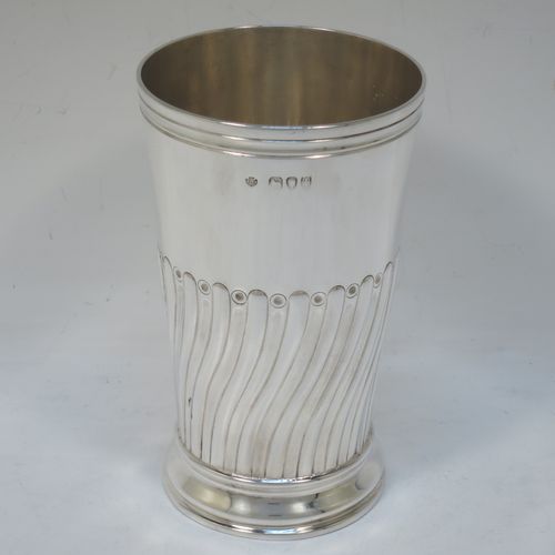 A handsome Antique Victorian Sterling Silver table flower vase, having a round body with straight tapering sides, with hand-chased half swirl-fluted decoration, and sitting on a collet foot. Made by the Barnard Brothers of London in 1894. The dimensions of this fine hand-made antique silver vase are height 14 cms (5.5 inches), diameter at top 8 cms (3 inches), and it weighs approx. 215g (7 troy ounces). Please note that this vase is not loaded.  