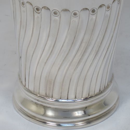 A handsome Antique Victorian Sterling Silver table flower vase, having a round body with straight tapering sides, with hand-chased half swirl-fluted decoration, and sitting on a collet foot. Made by the Barnard Brothers of London in 1894. The dimensions of this fine hand-made antique silver vase are height 14 cms (5.5 inches), diameter at top 8 cms (3 inches), and it weighs approx. 215g (7 troy ounces). Please note that this vase is not loaded.  