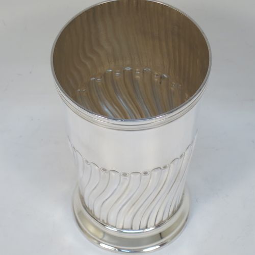 A handsome Antique Victorian Sterling Silver table flower vase, having a round body with straight tapering sides, with hand-chased half swirl-fluted decoration, and sitting on a collet foot. Made by the Barnard Brothers of London in 1894. The dimensions of this fine hand-made antique silver vase are height 14 cms (5.5 inches), diameter at top 8 cms (3 inches), and it weighs approx. 215g (7 troy ounces). Please note that this vase is not loaded.  