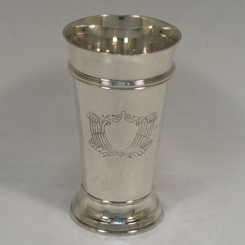 A very elegant Antique Victorian Sterling Silver table flower vase, having a round body with tapering sides, having hand-hammered decoration and an applied reeded upper band, with a vacant cartouche on one side, and all sitting on a pedestal foot. This handsome antique silver vase was made by Moss Morris of London in 1899. The dimensions of this fine hand-made antique silver vase are height 14 cms (5.5 inches), diameter at top 8 cms (3 inches), and it weighs approx. 226g (7.3 troy ounces).  