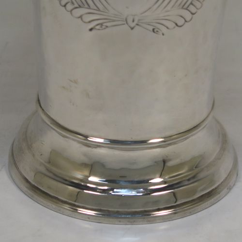 A very elegant Antique Victorian Sterling Silver table flower vase, having a round body with tapering sides, having hand-hammered decoration and an applied reeded upper band, with a vacant cartouche on one side, and all sitting on a pedestal foot. This handsome antique silver vase was made by Moss Morris of London in 1899. The dimensions of this fine hand-made antique silver vase are height 14 cms (5.5 inches), diameter at top 8 cms (3 inches), and it weighs approx. 226g (7.3 troy ounces).  