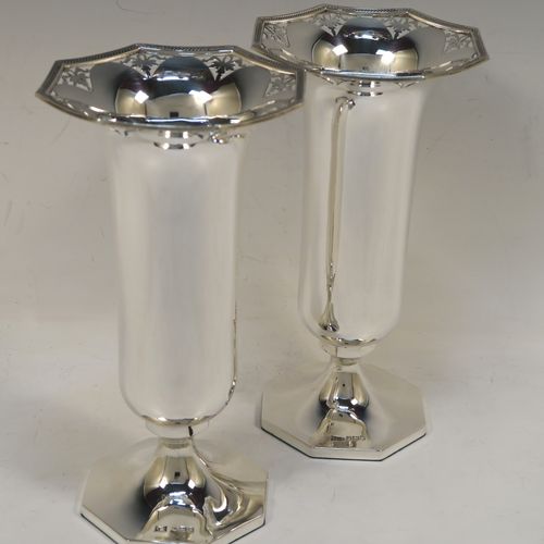 A very pretty pair of Sterling Silver table flower vases, having plain round bodies with tapering sides, with hand-pierced and applied rope-twist top borders, and sitting on plain hexagonal pedestal feet. These beautiful silver vases were made by Walker and Hall of Sheffield in 1924. The dimensions of this fine hand-made silver pair of vases are height 19 cms (7.5 inches), and width at top 10 cms (4 inches).    