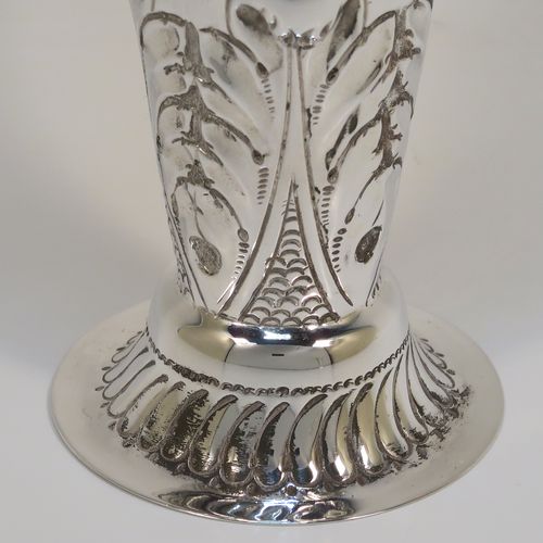 A very pretty Antique Victorian Sterling Silver pair of table flower vases, having round hand-chased bodies with tapering sides, with floral and fluted decoration, and all sitting on pedestal feet. These beautiful antique silver vases were made by Mappin and Webb of London in 1896. The dimensions of these fine hand-made antique silver pair of vases are height 16 cms (6.25 inches), diameter at top 6.5 cms (2.5 inches), and they weigh at total of approx. 200g (6.5 troy ounces). Please note that these vases are not loaded, so the whole weight is silver.   