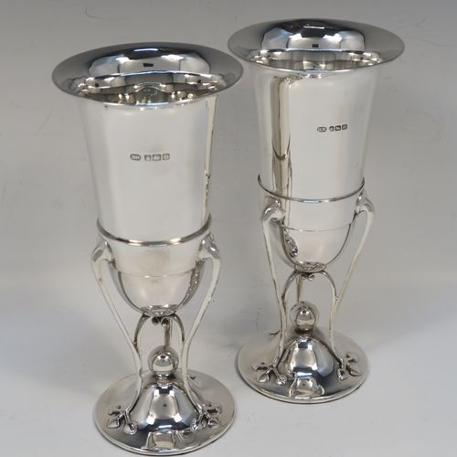 A very pretty and unusual pair of Antique Art Nouveau style Edwardian Sterling Silver vases, having plain round central bodies with tapering sides, attached to round spreading bases with three tendril and leaf style arms. These beautiful silver vases were made by Richard Richardson of Sheffield in 1904. The dimensions of this fine pair of hand-made antique silver Art Nouveau vases are height 19 cms (7.5 inches), and diameter at lips 8.5 cms (3.3 inches).   