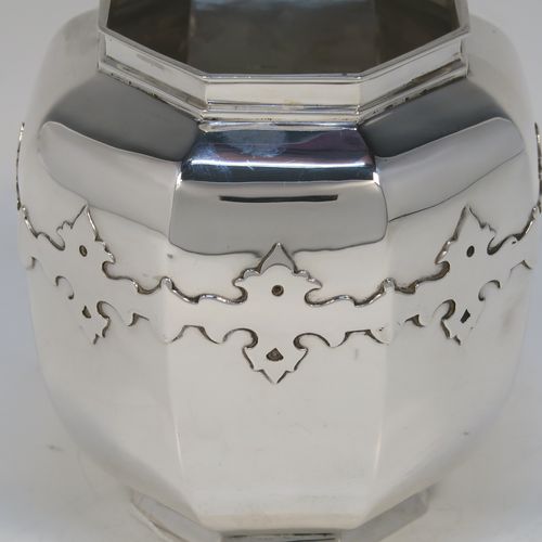 A very elegant and unusual Arts and Crafts style Antique Sterling Silver table flower vase, having an octagonal panelled bellied body, with an applied upper band of cut-card work decoration, and sitting on an octagonal collet foot. This elegant silver vase was made by London in 1911. The dimensions of this fine hand-made antique silver flower vase are height 11 cms (4.25 inches), diameter at top 7 cms (2.75 inches), and with a weight of approx. 214 g (6.9 troy ounces).   