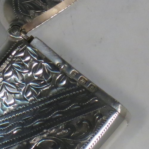 An Antique Edwardian Sterling silver Vesta case, having a rectangular body, with hand-engraved floral decoration, a hinged lid with security ring for attaching to a chain, a gold-gilt interior, and a vacant cartouche on one side. Made in Birmingham in 1905. The dimensions of this fine hand-made antique silver Vesta case are length 5.5 cms (2.2 inches), width 4 cms (1.5 inches), and it weighs approx. 29g (1 troy ounce).   