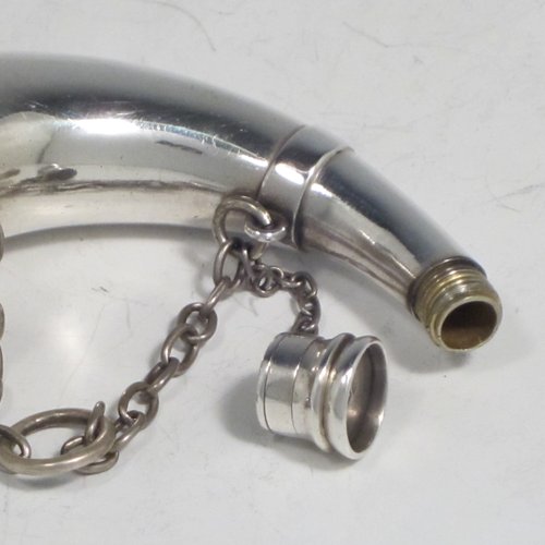 Antique Victorian sterling silver combination vinaigrette and scent bottle, in the shape of a horn, having a plain round body, with attached security chains, a main hinged cover with a gold-gilt interior, a hinged hand-pierced and engraved internal grill, and a another screw-top cover for adding perfume. Made by Thomas Johnson of London in 1875. The dimensions of this fine hand-made silver combination vinaigrette and scent bottle are length 9 cms (3.5 inches), width 3.5 cms (1.3 inches), and it weighs approx. 55g (1.8 troy ounces).