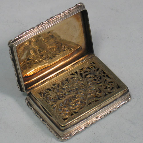 Antique Georgian sterling silver and gold-gilt vinaigrette with engine-turned decoration and cast upper & lower borders (engraved M.N. Thomas). Made in Birmingham, 1835. Length 3.7 cms.